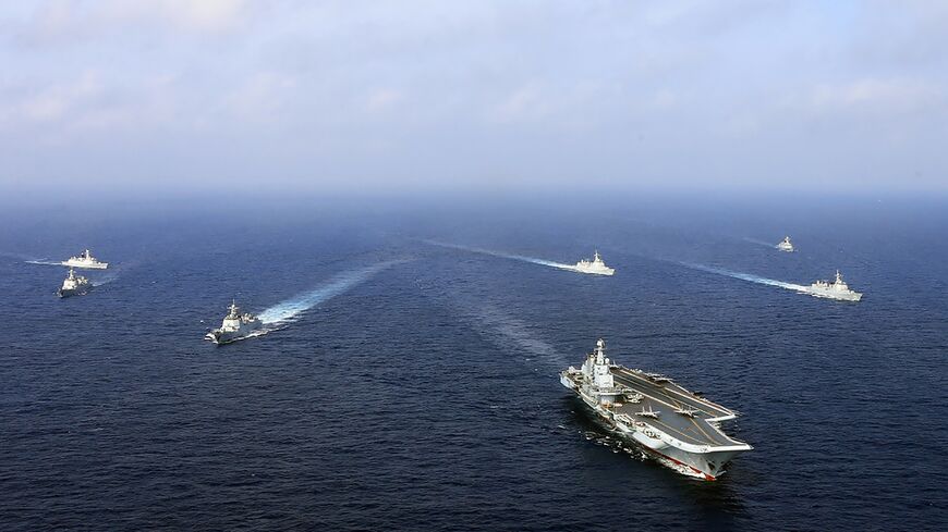 This undated photo taken in April 2018 shows China's sole operational aircraft carrier, the Liaoning (front), sailing with other ships during a drill at sea.